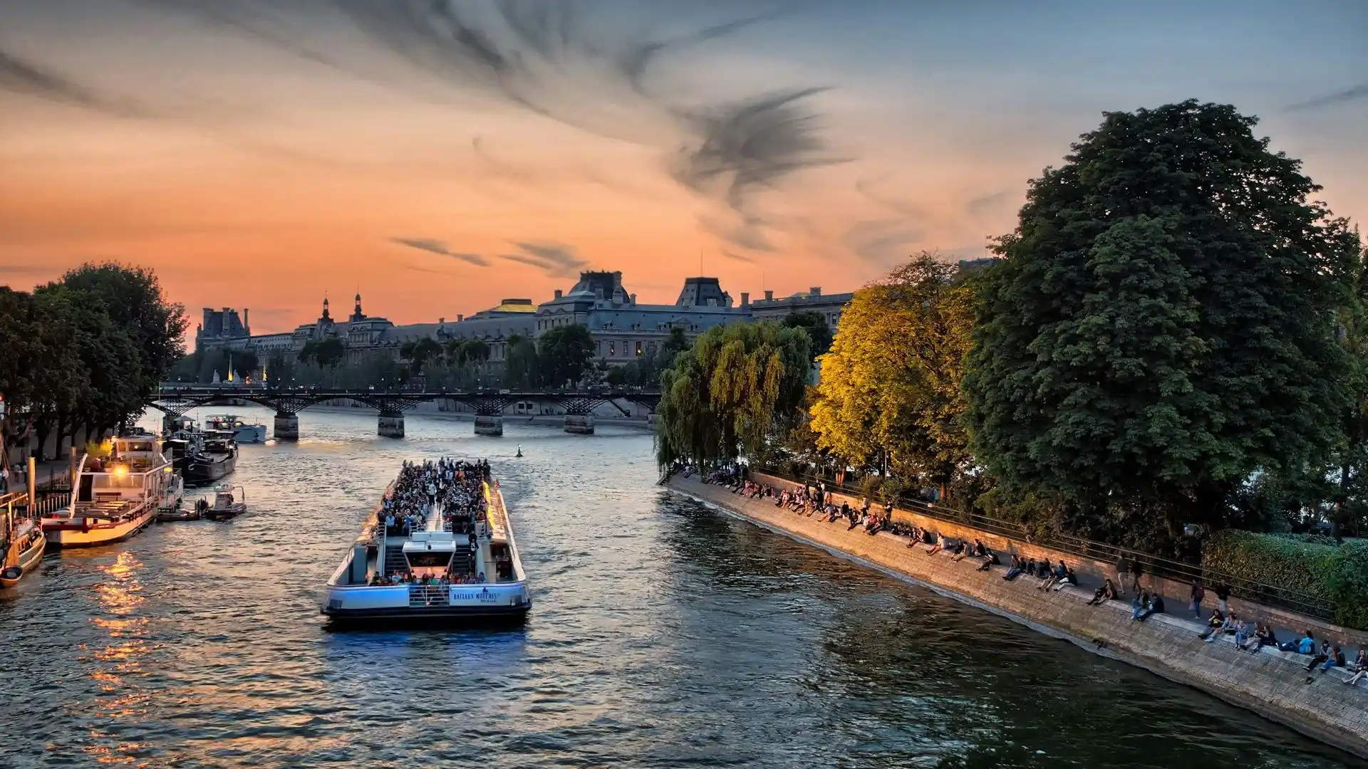 Sightseeing boat on the Seine at sunset in central Paris
