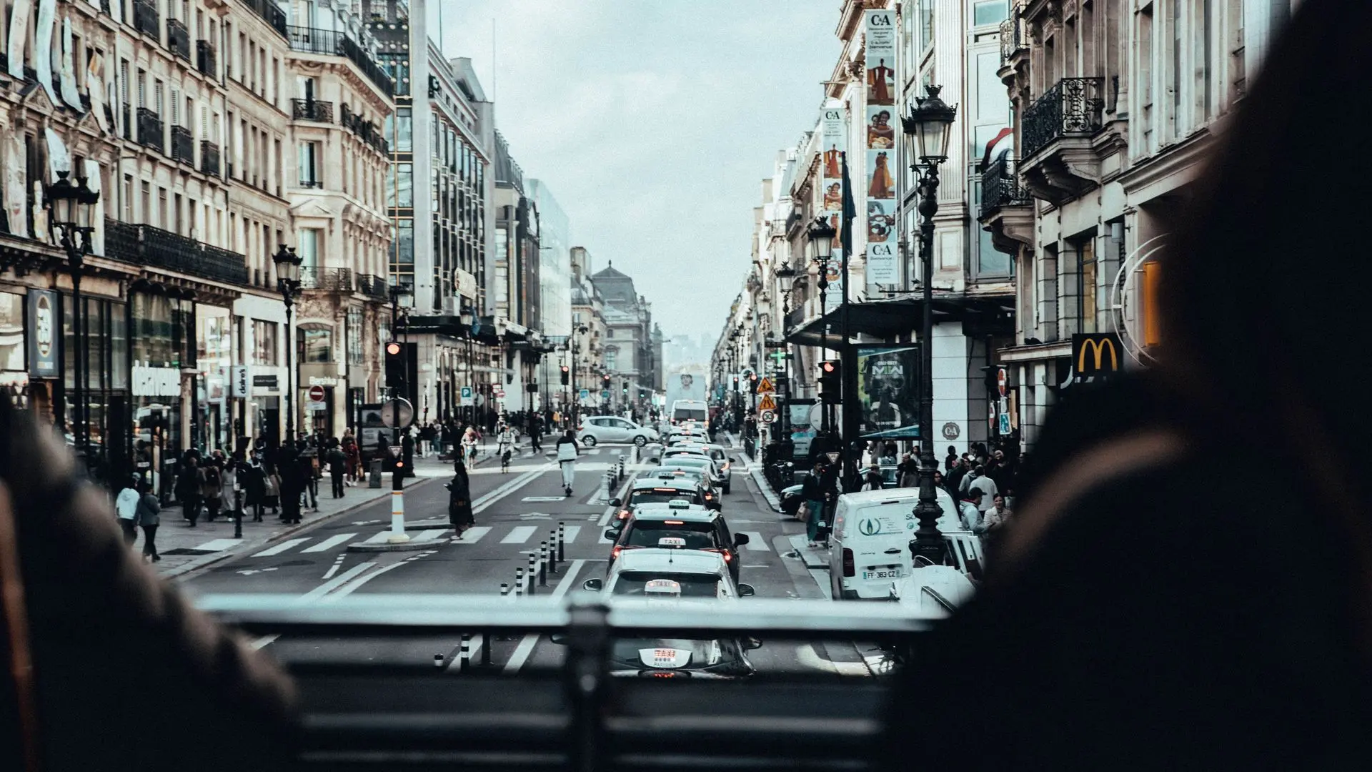 View down a Paris boulevard from the upper deck of a sightseeing bus View down a Paris boulevard from the upper deck of a sightseeing bus