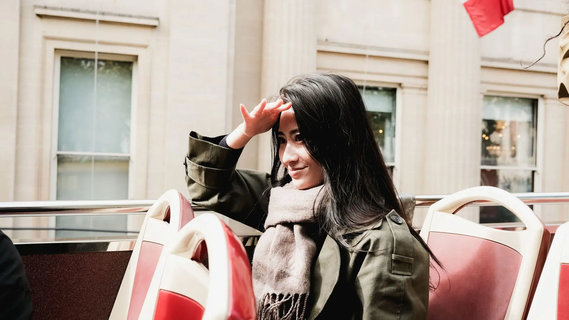Passenger on the open upper deck of a sightseeing bus in Paris