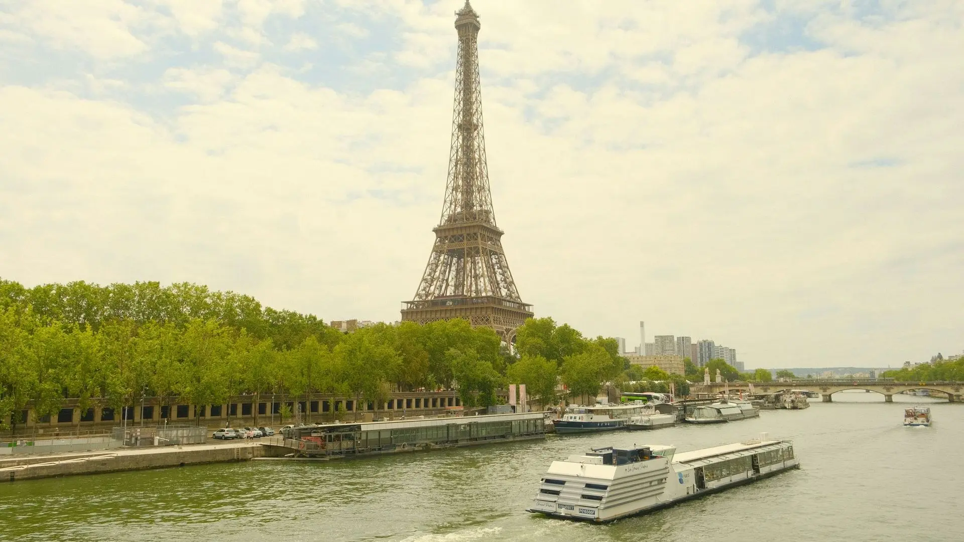 Eiffel Tower above a sightseeing boat on the Seine